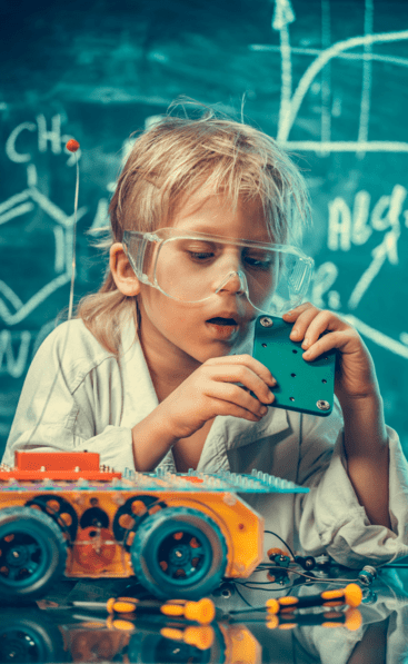 Kid with safety glasses building a car